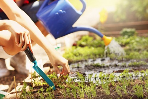 Gardener working safely in manor house grounds